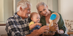 Grandparents kissing a baby